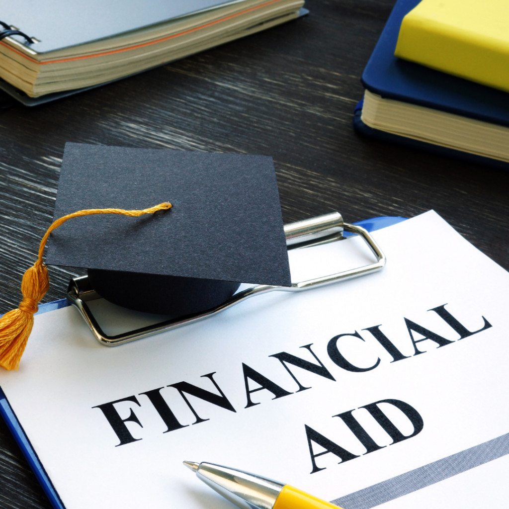 A piece of paper with "Financial Aid" typed across it and a graduation cap 