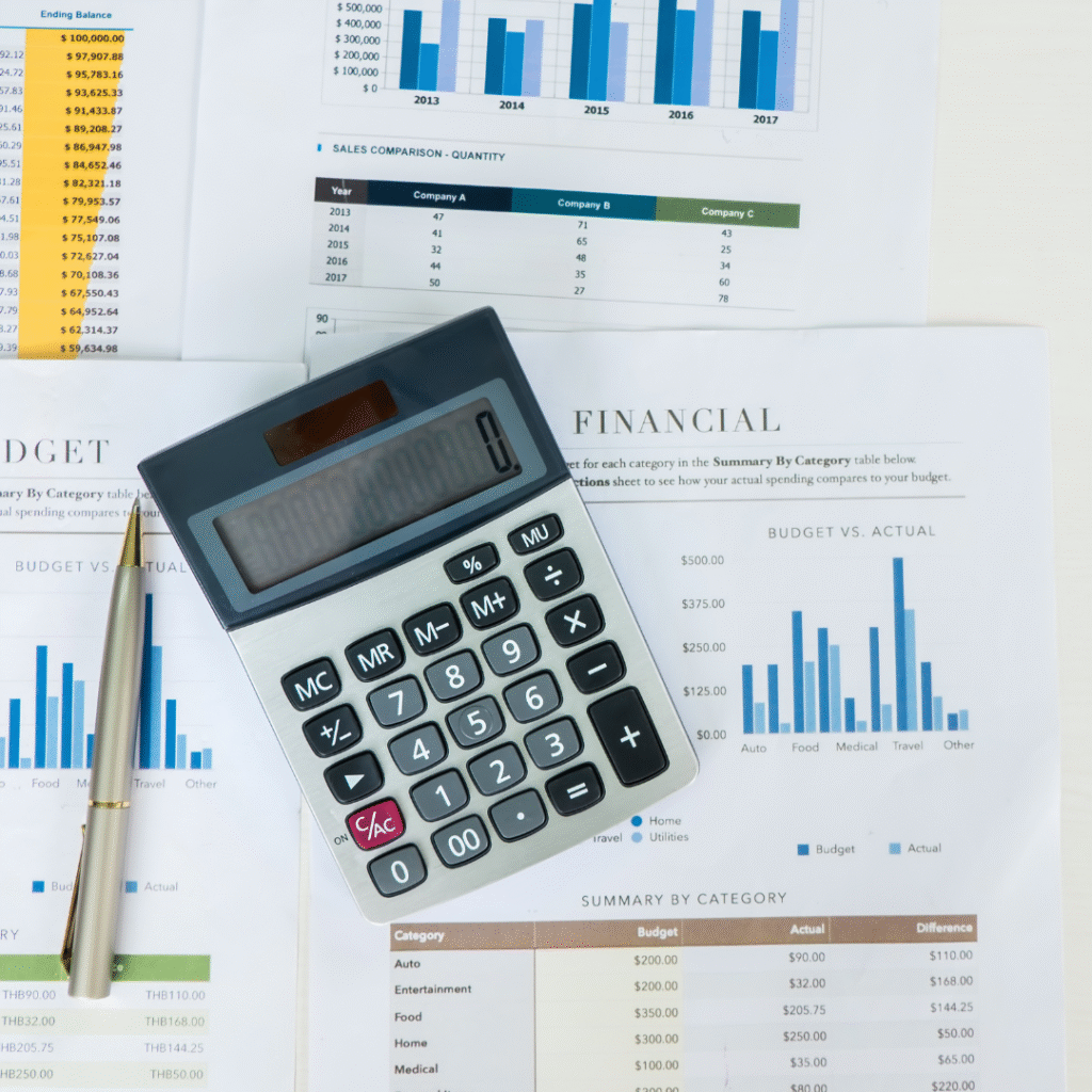 A calculator on top of a stack of financial papers